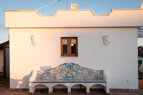 a white building with a bench on it at Raciti Palace in Acireale
