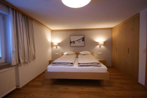 a bedroom with a bed with two pillows on it at Soldanella in Lech am Arlberg