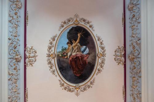 a painting of a woman holding a star on a wall at Raciti Palace in Acireale