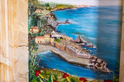 a painting of a beach and the water at Raciti Palace in Acireale