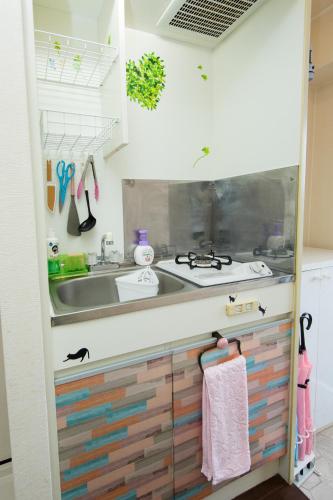 a kitchen with wooden drawers and a sink at Cozy house 411 free wifi a rented electric bicycle in Kyoto