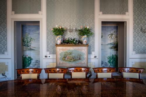a room with a row of chairs and a table at Raciti Palace in Acireale