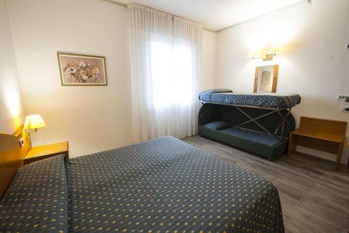 Ένα ή περισσότερα κρεβάτια σε δωμάτιο στο Hotel Italia