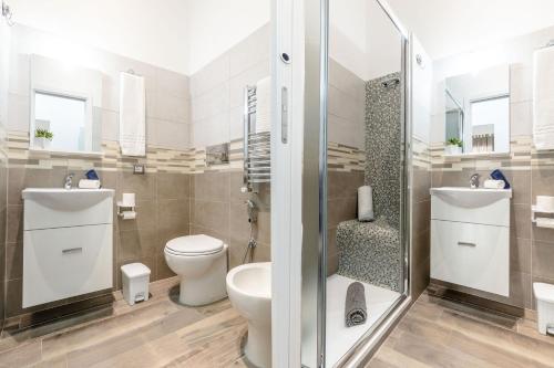 a bathroom with a toilet and a shower at Scirocco Rooms in Civitavecchia