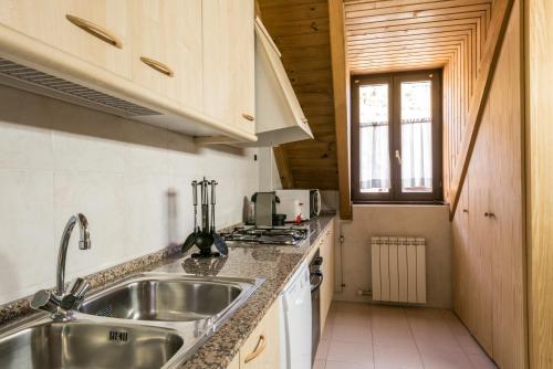 a kitchen with a sink and a stove at Montcorbison by Totiaran in Vielha