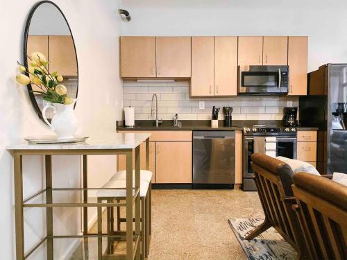 a kitchen with a table with a vase of flowers on it at Cozy Downtown Loft in Knoxville