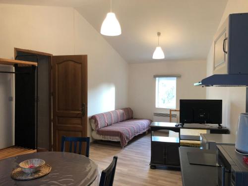 a living room with a couch and a table at Gite Augirons in Saint-Ciers-sur-Gironde