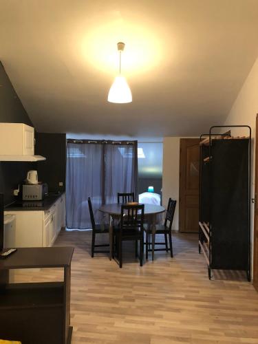 a kitchen and dining room with a table and chairs at Gite Augirons in Saint-Ciers-sur-Gironde