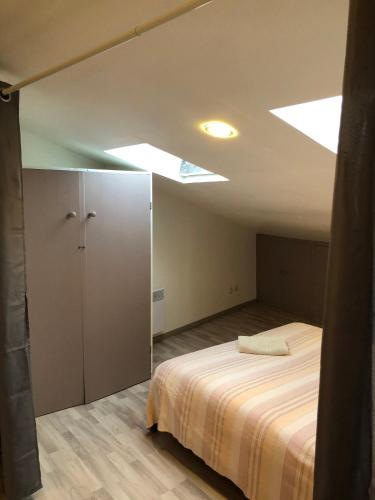 a bedroom with a bed and a ceiling with lights at Gite Augirons in Saint-Ciers-sur-Gironde