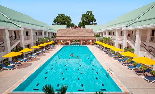 an overhead view of a swimming pool with chairs and umbrellas at Thanyapura Sports & Health Resort in Thalang