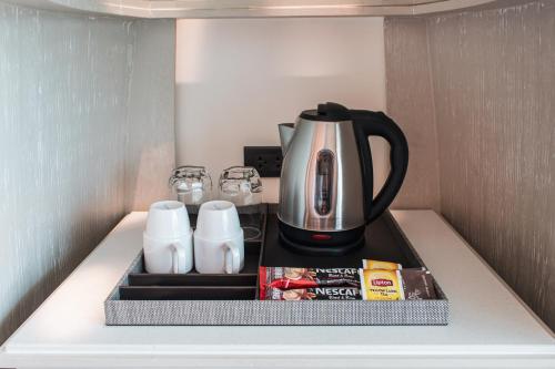 a coffee maker on a shelf in a refrigerator at Rachabhura Hotel in Ratchaburi