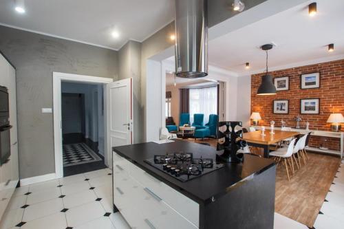 a kitchen and living room with a table and a dining room at Villa Adam in Pieszyce