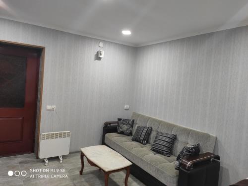a living room with a couch and a chair at Mziuri Guest House in Mestia