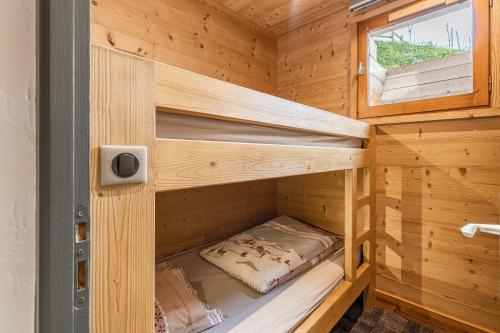 a wooden cabin with two bunk beds in it at La Duche 101 in Le Grand-Bornand