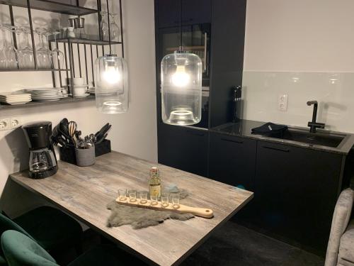 a kitchen with a table with a baseball bat on it at Chalet Mirandum Apartments Vandans in Vandans