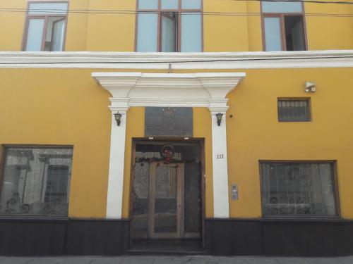 un edificio amarillo con una puerta en el medio en Estela de Oro Hotel Boutique, en Arequipa