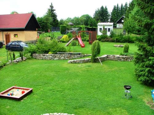 a backyard with a playground and a play area at Apartmány Nové Hutě in Nové Hutě