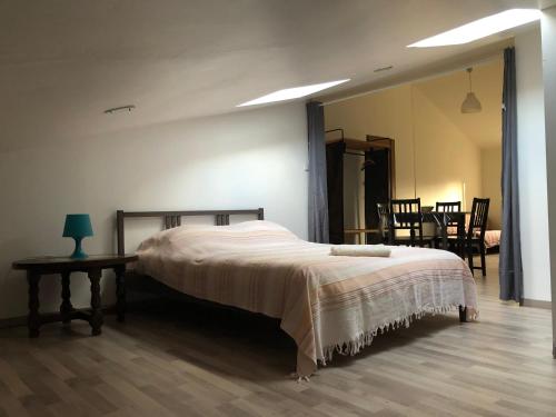 a bedroom with a bed and a table and a mirror at Gite Augirons in Saint-Ciers-sur-Gironde