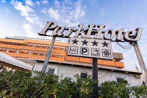 a sign for a ralphodge hotel in front of a building at Park Hotel in Rimini