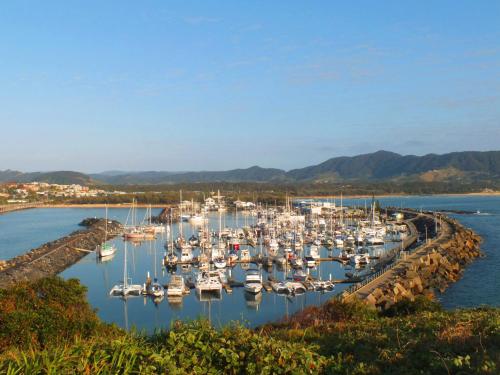 a bunch of boats are docked in a harbor at Pacific Marina Apartments in Coffs Harbour