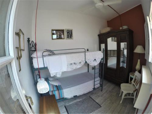 a bedroom with a bunk bed with a curtain at Andiamo Guest House in Buenos Aires