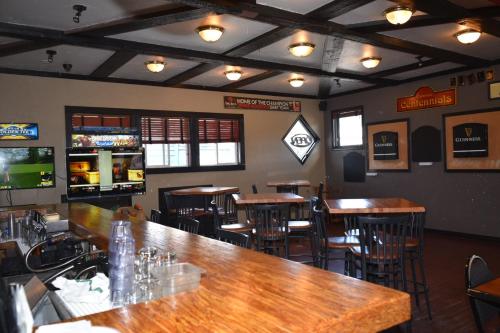 a bar with wooden tables and chairs in a restaurant at The Drake Inn in Canmore