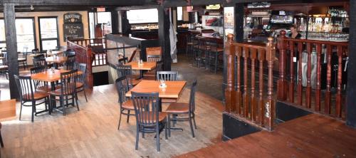 a restaurant with wooden tables and chairs and a bar at The Drake Inn in Canmore