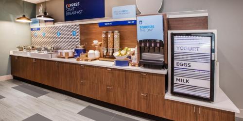 a cashier counter in a grocery store with a sign in front at Holiday Inn Express & Suites - Lindale by IHG in Lindale
