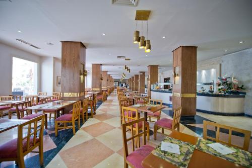 a dining room with wooden tables and chairs at Amphoras Aqua in Sharm El Sheikh