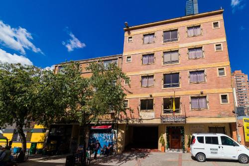 a white van parked in front of a brick building at Hotel Virrey Central in Bogotá