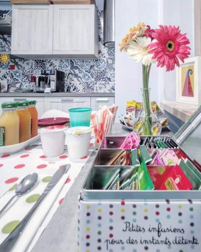a kitchen counter with a sink and a vase of flowers at Museo19 in Naples