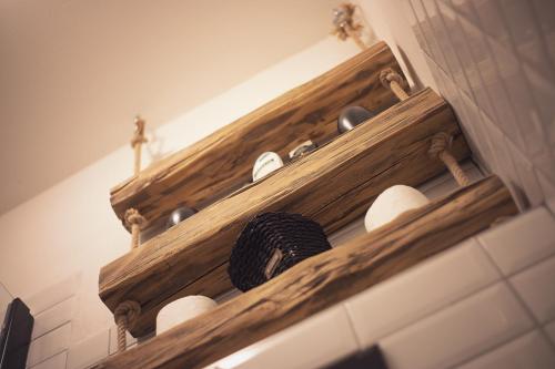 a wooden shelf on a wall with dishes on it at U Svatého Petra in Kájov