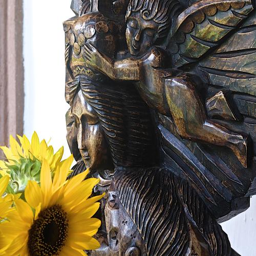 a statue next to a bunch of sunflowers at Casa de la Real Aduana Boutique Hotel in Pátzcuaro
