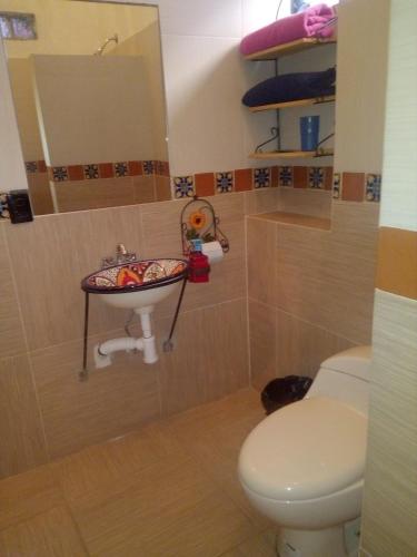 a bathroom with a toilet and a sink at Casa Santuario Hotel Boutique in Guadalajara