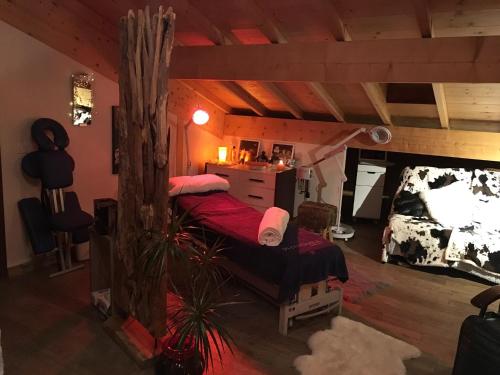 a bedroom with a bed in a log cabin at Montagn'Arcs in Bourg-Saint-Maurice