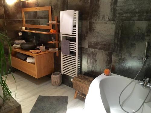 a bathroom with a bath tub and a sink at Montagn'Arcs in Bourg-Saint-Maurice