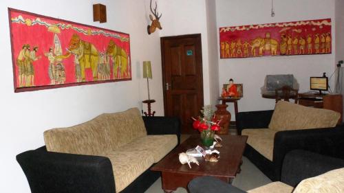 a living room with two couches and a table at Morning Star in Mirissa
