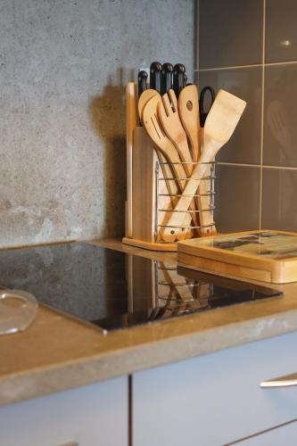 a kitchen counter with wooden utensils on a cutting board at Apartment by the Sea in Porto