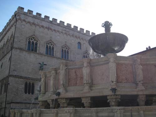 a building with a street light in front of it at Hotel Vega Perugia in Perugia