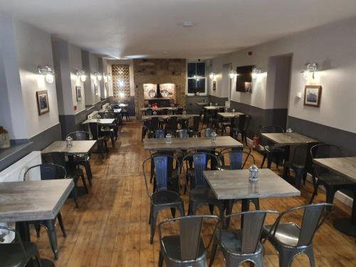 a restaurant with tables and chairs in a room at Fountain Cottage Cafe and B&B in Bellingham