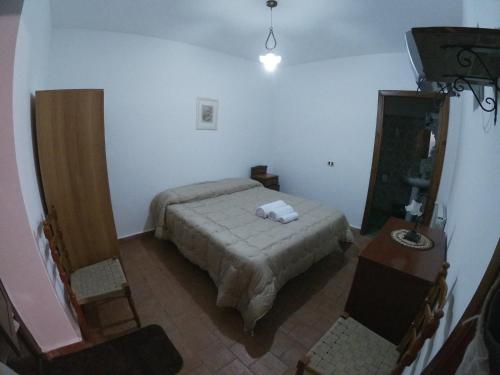 a bedroom with a bed and a table and a television at SESIMA turismo rurale in Mistretta