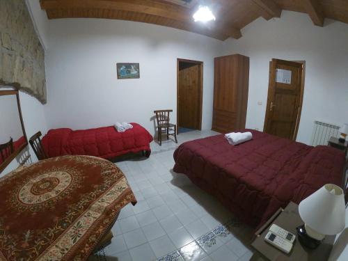 a bedroom with two beds and a chair and a table at SESIMA turismo rurale in Mistretta