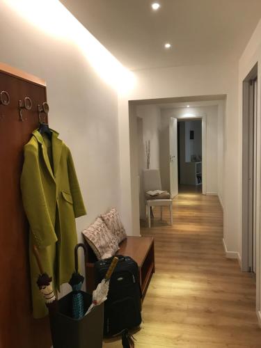 a living room with a couch and a coat on a wall at Charming 25 Apartment in Rome