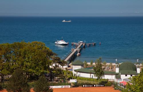 a boat is docked at a dock in the water at Hotel Stranddistel Rügen in Göhren