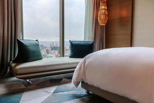 a bedroom with a bed and a large window at Sofitel Mexico City Reforma in Mexico City