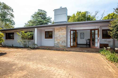 a house with a brick driveway in front of it at Mason Winery in Mount Tamborine
