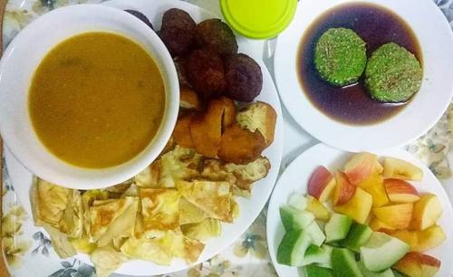 a plate of food with a bowl of soup and dip at M's Place Chalet Bed&Breakfast in George Town