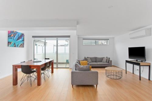 a living room with a couch and a table at Phillip Island Townhouses in Cowes