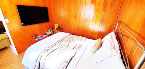 a bedroom with a bed and a flat screen tv at Time Traveler Retreat in Julian