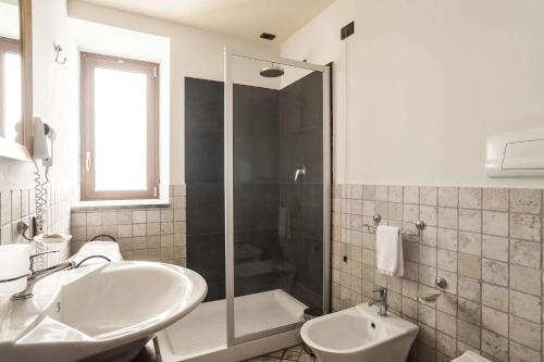 a bathroom with a shower and a sink and a tub at Best Western Hotel Santa Caterina in Acireale